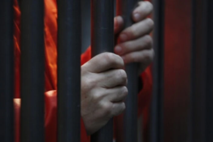 A young man in a prison cell