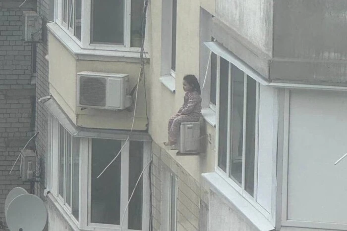 Girl on the air conditioner on the 8th floor