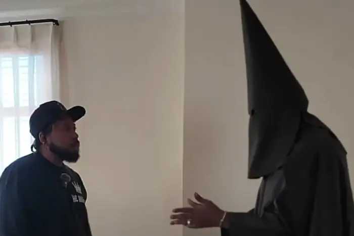 Musician in a Ku Klux Klan suit