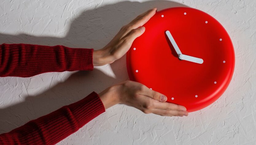 Clock with hands on a winter background